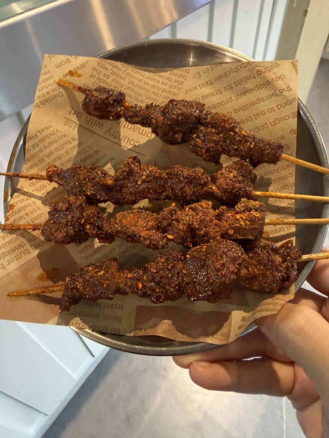 A close-up plate of assorted fried skewers at Bomb Fried Skewers